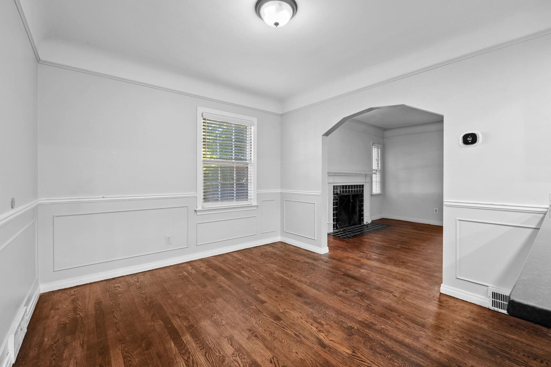 Dining room with arched opening to the living room and fireplace at 3963 Yorkshire
