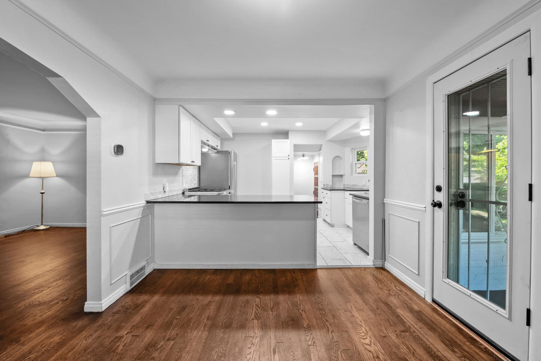 Dining room with wainscoting and a glass door leading to the sun room at 3963 Yorkshire