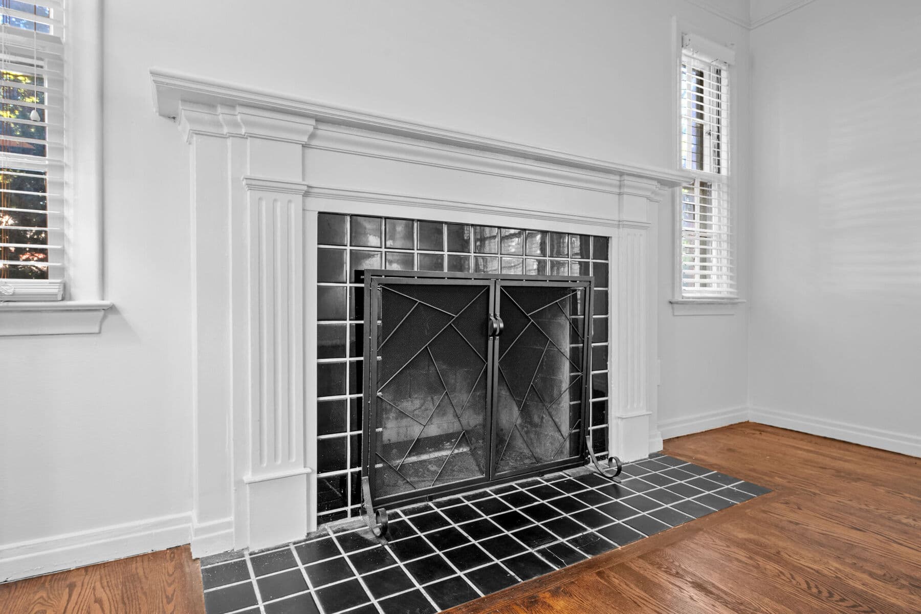 Classic fireplace with white mantel and black tile surround in the living room at 3963 Yorkshire, Detroit