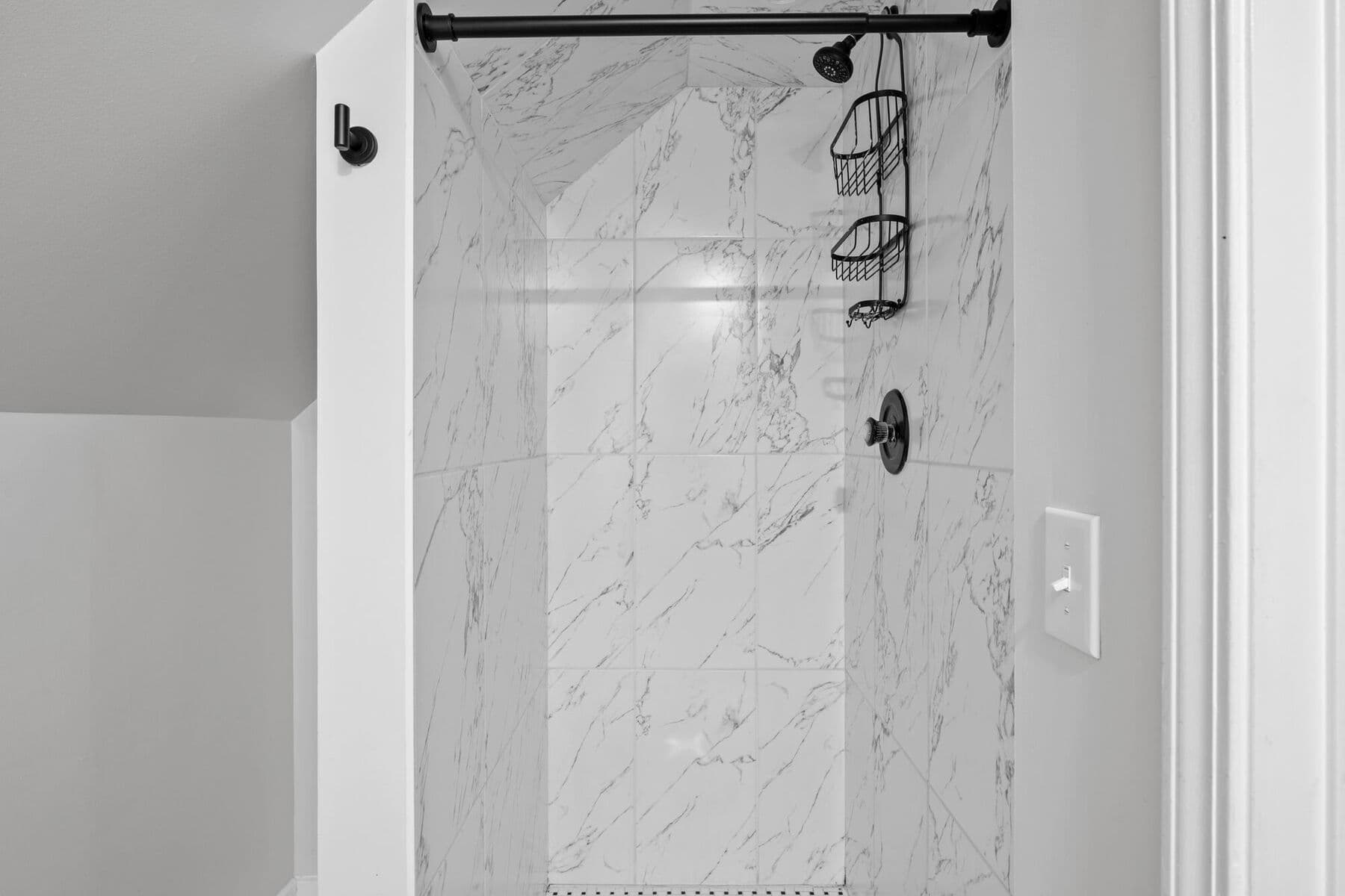 Primary suite bathroom with marble-look tiled walk-in shower at 3963 Yorkshire