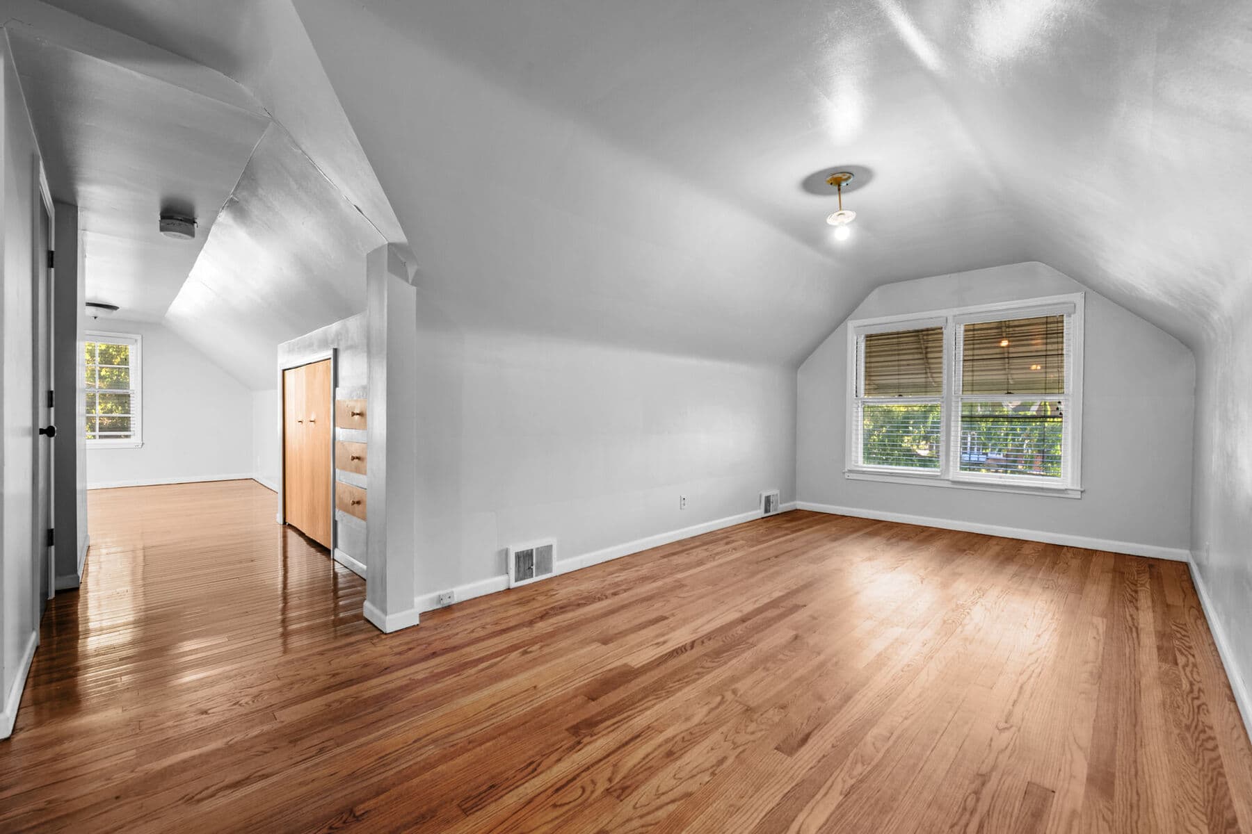 Second-floor primary suite with sloped ceilings and hardwood floors at 3963 Yorkshire, Detroit