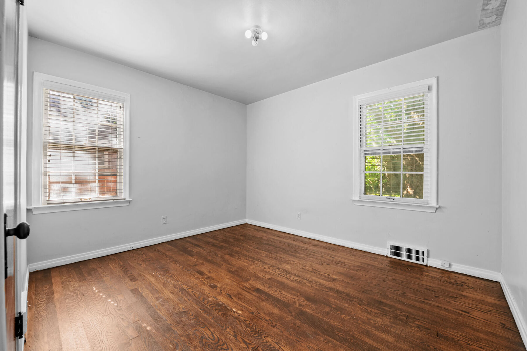 Main-level bedroom with windows on two walls at 3963 Yorkshire