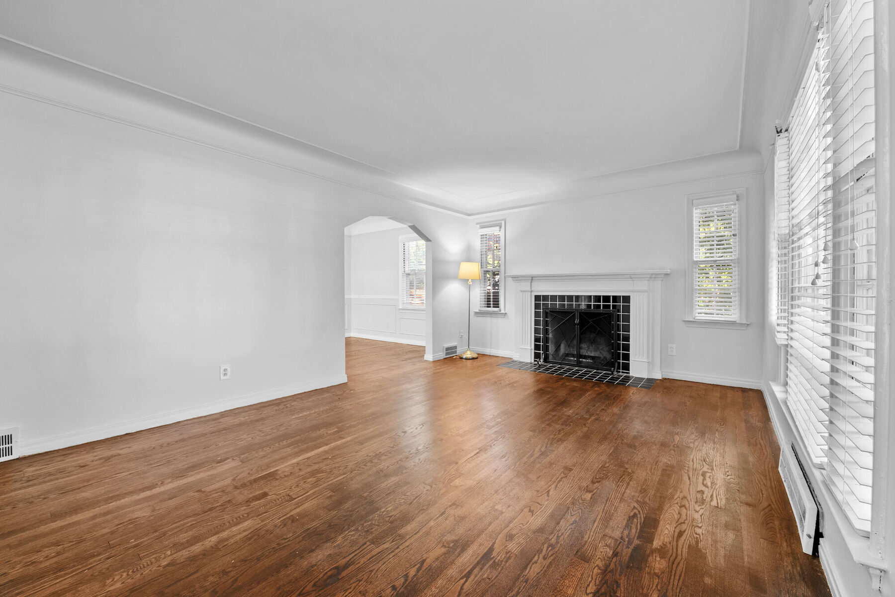 Living room bathed in natural light with fireplace and hardwood floors at 3963 Yorkshire