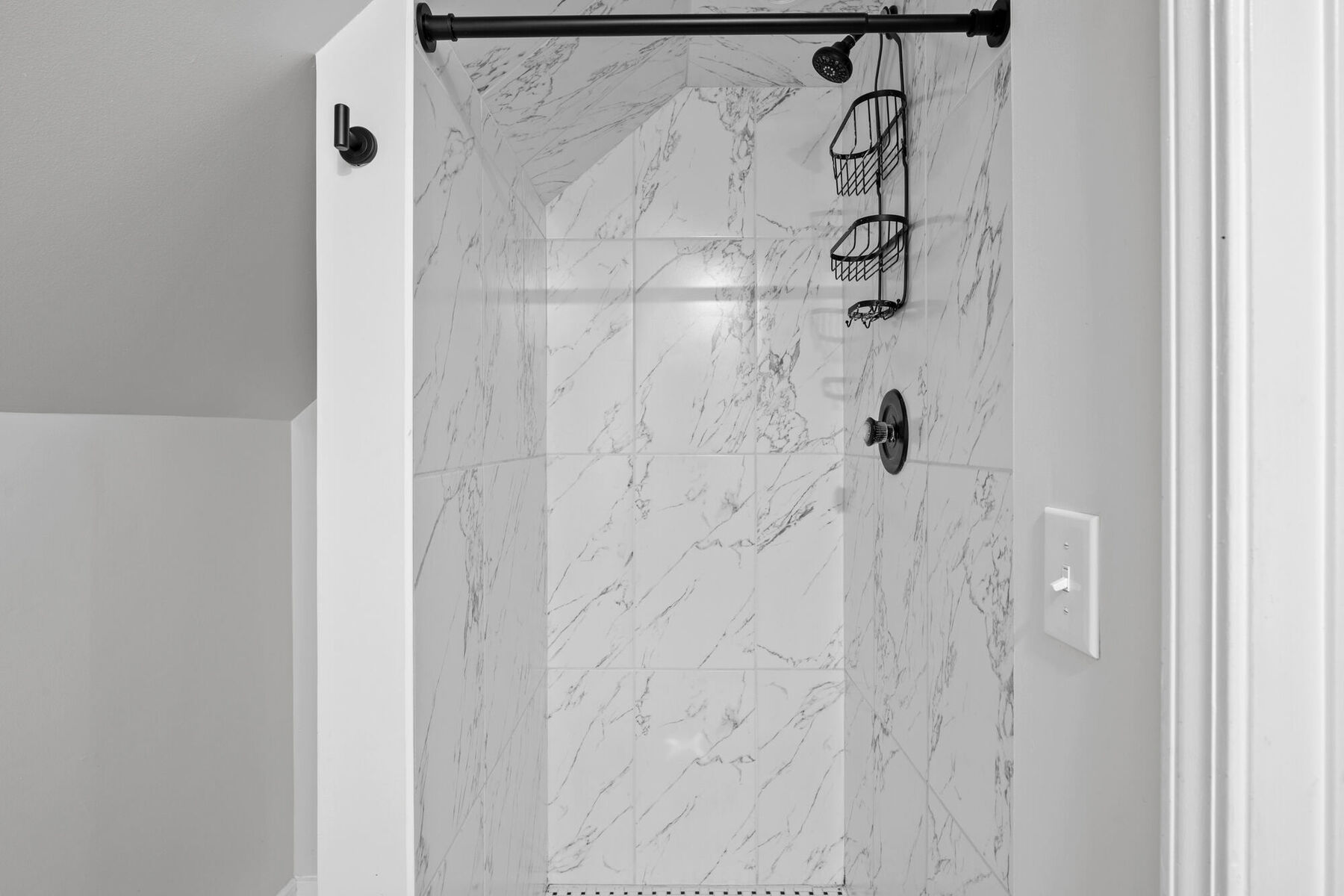 Primary suite bathroom with marble-look tiled walk-in shower at 3963 Yorkshire